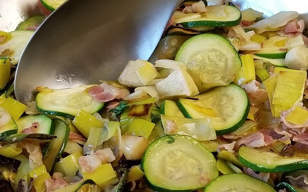 Add the zucchini and thyme leaves, then sauté for 5 to 6 minutes, stirring occasionally, until the zucchini is tender.