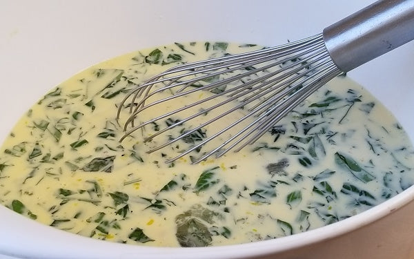 Whisk together the eggs, half-and-half, salt and pepper in a large bowl. Then fold in two-thirds of the Gruyere and all of the basil. 