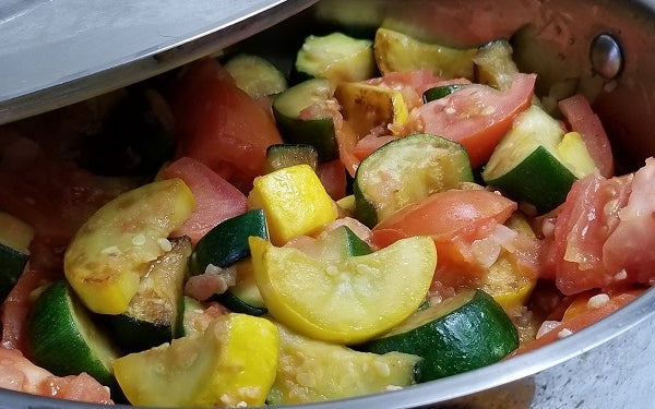 Add the diced onion and minced garlic, sauté an additional 3 minutes. Then stir in the tomatoes, mix thoroughly, cover and simmer on low heat for about 15 minutes. 