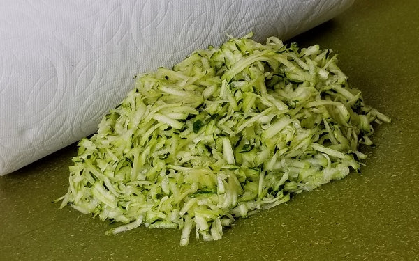 Shred zucchini and squeeze dry with cheese cloth / then paper towels.