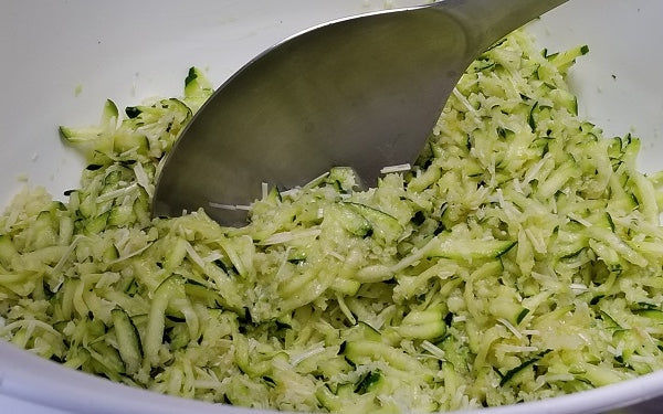 Mix shredded zucchini with egg, Parmesan, panko, garlic and pepper together.