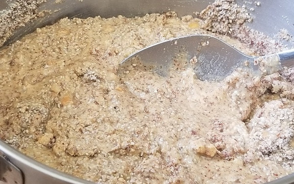 In a medium saucepan over medium heat, melt coconut oil, peanut butter and powdered sweetener together until smooth. Stir in protein powder, almond flour and chia seeds until thoroughly combined. 
