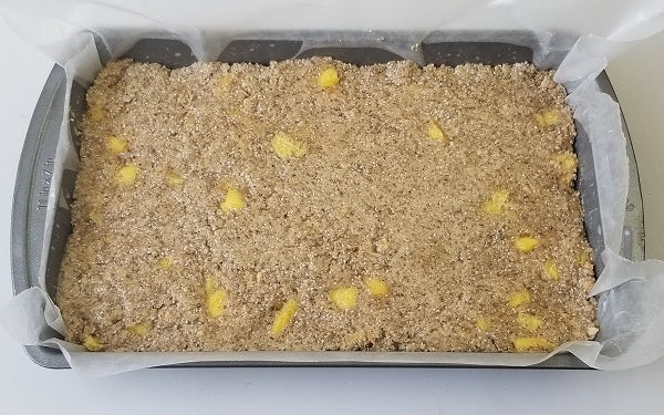Gently fold the chopped mangoes into the peanut mixture, then transfer to 7x11-inch pan with parchment or waxed paper, spread evenly to the edges of the pan and refrigerate until set, at least two hours. 