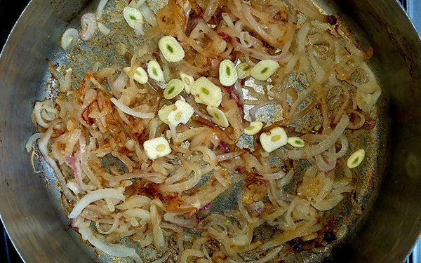 Place 2 tablespoons butter into a 12-inch sauté pan and heat on medium till melted. Add sliced onions and shallots, dust with sugar, then mix with a fork to combine. Reduce heat to low and cook the onion mixture till soft, sweet and caramelized (onions should be a golden/brown color). 