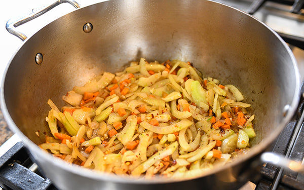 In a 5-quart saucepan or Dutch oven, heat olive oil over medium high heat. Add onion and fennel and sauté for 4 to 5 minutes or until softened, but not browned. Add carrots and garlic and cook for 1 – 2 minutes.