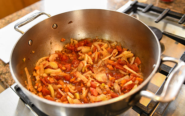 Add wine and cook for 3 – 4 minutes or until mostly evaporated. Add tomatoes, Italian seasoning and chili flakes and simmer for 2 minutes or until heated through. Add beans and stir well.