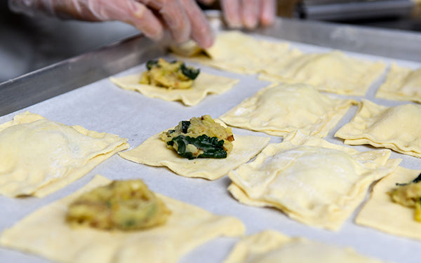 Remove the puff pastry from the box, one sheet at a time. Use a rolling pin to roll the sheet out, cut each sheet into 12 even squares. Place some of the filling on half the squares and then cover with the remaining squares. Press the edges with your fingers and then press again with a fork to seal.