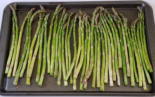 Toss asparagus with 1 TBS oil, arrange on a baking sheet in a single layer, season with salt and pepper. Roast @ 350° until tender, about 10 minutes.