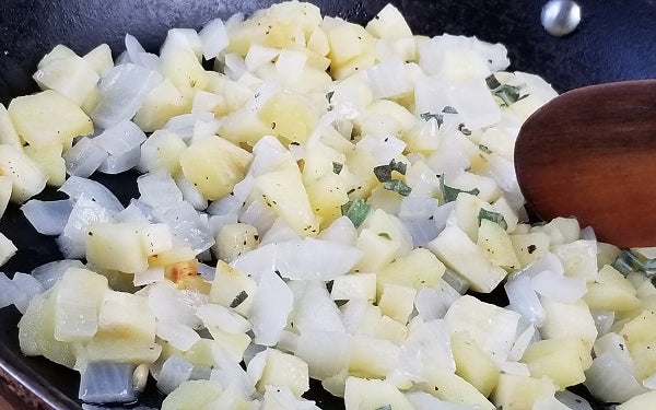 In a large skillet, heat oil over medium heat, then sauté the apple, onion and parsnip with celery seed, sage and ½ teaspoon of salt until softened, 4-5 minutes.