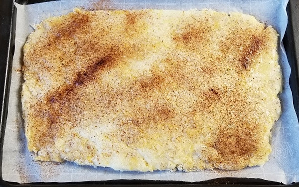 Image of dough in pan with cinnamon