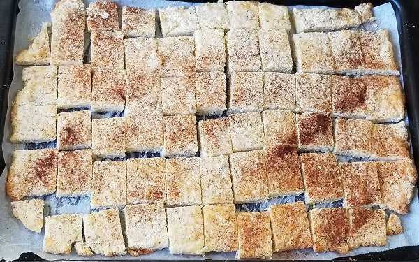 Image of dough in pan cut into squares