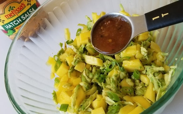 In a small bowl, gently stir together the avocado, mango, green onions and salsa until well combined. 