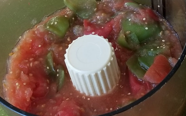 Tomatoes and tomatillos in a food processor