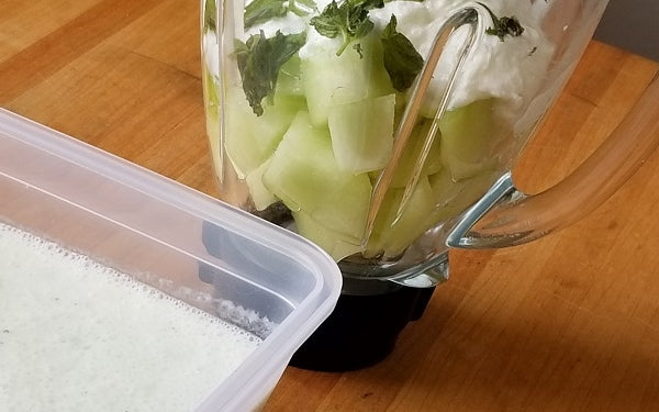 Place melon, mint, and 2 cups of yogurt in a blender and purée until smooth.