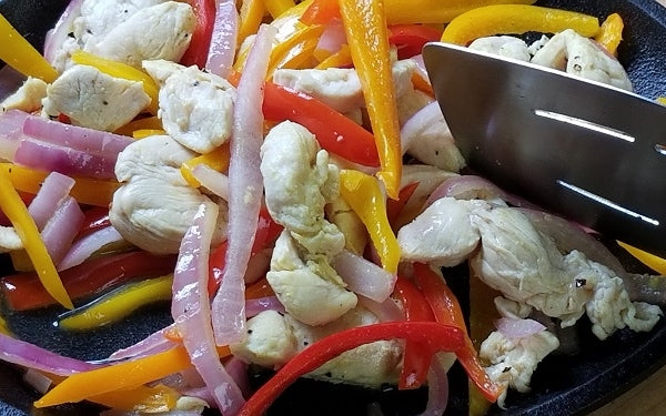 Heat oil in an iron skillet or fajita pan, sauté chicken strips over medium heat for 4 minutes.