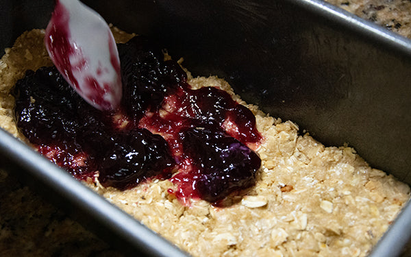 Spread the jam evenly over the oat mixture. 