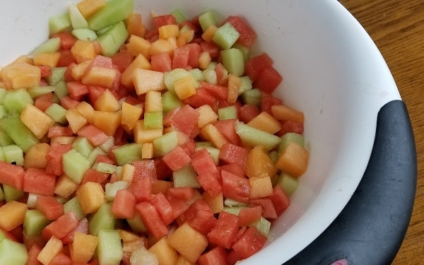 Trim off the rind of all 3 melons, remove all seeds and small dice (½-inch). Put all of the diced melon pieces in a large mixing bowl and set aside.