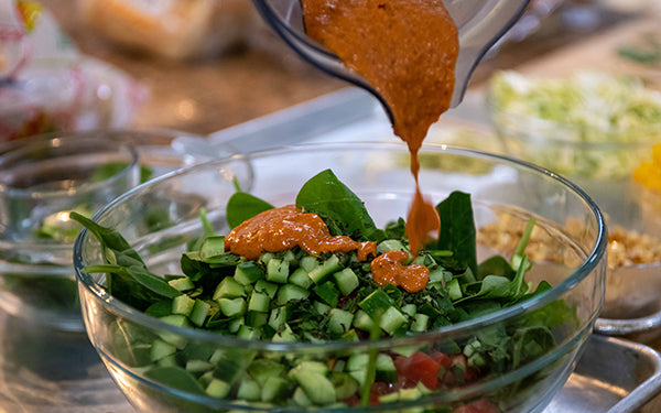 Pour half of the prepared dressing over the salad and toss well. Season with salt and pepper and serve immediately.