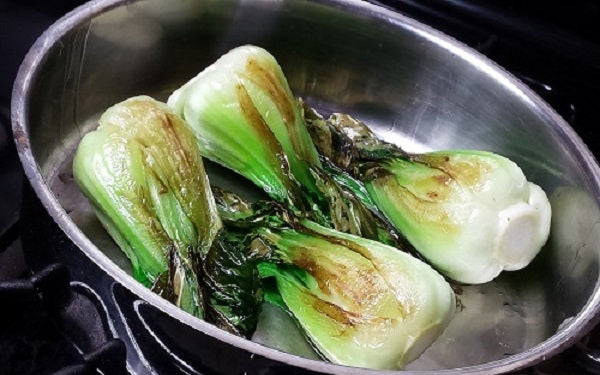 Under close adult supervision, carefully heat up the oil in a deep sauté pan over a medium flame setting, then sauté the baby bok choy until slightly browned (about 2 minutes on each side).