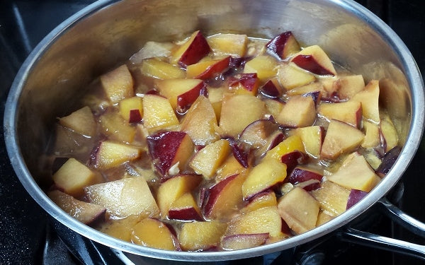 Using the same sauté pan, add in the chopped plums, garlic, stock, soy sauce and ginger powder, then simmer the mixture into a sauce, stirring occasionally.