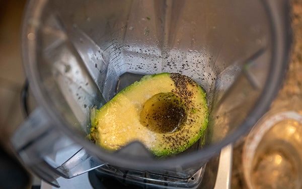 To make the dressing put the avocado, lime and olive oil in a blender. 