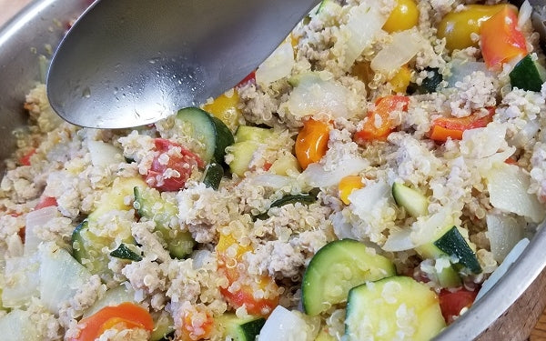 Add in the quinoa over the veggies and then the ground turkey over the quinoa. Stir all together thoroughly on low heat to allow for quinoa and turkey to heat back up and for veggies to finish cooking. 