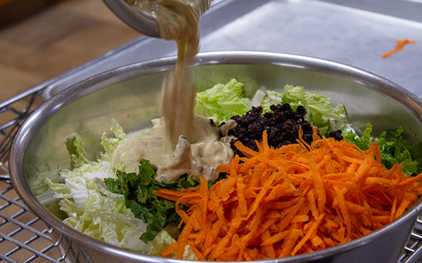 In a large bowl, combine the cabbage and carrots. Add dressing, currants and cilantro and stir well.