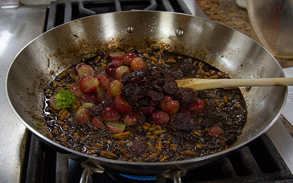 To make the Muscato™ grape agrodolce, heat the olive oil in a sauté pan and then add the onion and pecans.