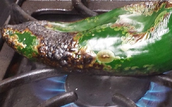 Roast the peppers over an open flame, using a pair of tongs for safety. Then peel, clean, medium dice and set aside.