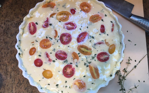 Pour batter into buttered quiche pan, then sprinkle thyme leaves and cheese on top of batter. 