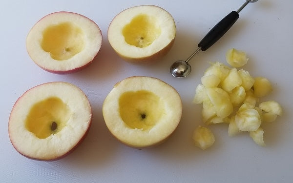 Slice each apple in half across the middle. Use a melon baller to cut out the core/seeds, then scoop out more of the fruit pulp to form small apple “bowls”. Save the removed fruit.