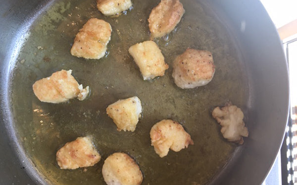 Heat oil over medium in a skillet till hot or simmering. Add scallops, making sure not to crowd