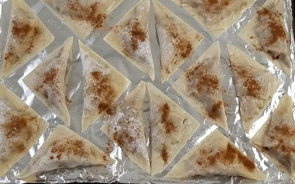 Place wontons on a cookie sheet lined in parchment paper or non-stick foil; sprinkle each with cinnamon.
