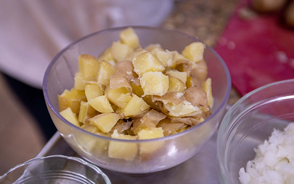 In a stock pot steam the potatoes for about 15-20 minutes until just tender. Remove from the heat, and set aside to cool. Cut into ¼” cubes.