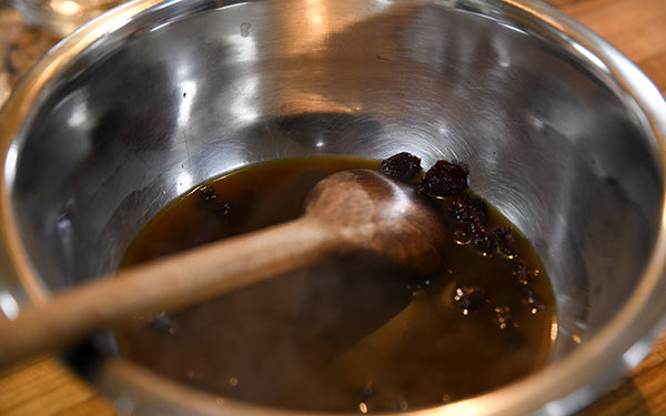 Image of dried cherries in mixing bowl with broth