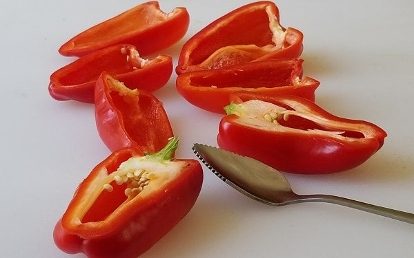 Slice the Mini Sweet Peppers in half lengthwise, remove seeds and ribs with serrated spoon.