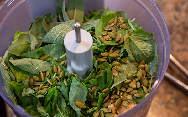 To make the pesto, combine all the ingredients except the water in a high speed blender.