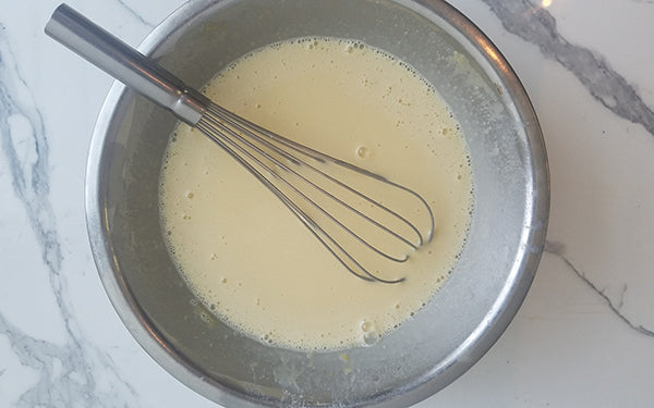 Place milk, sugar, eggs, vanilla, salt, and flour in a large bowl and gently mix. 