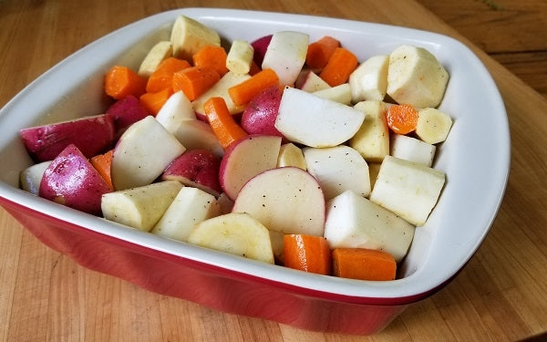 Once the vegetables have been prepared, place them all together in a large bowl or plastic bag and toss with olive oil, salt & pepper until thoroughly coated. 