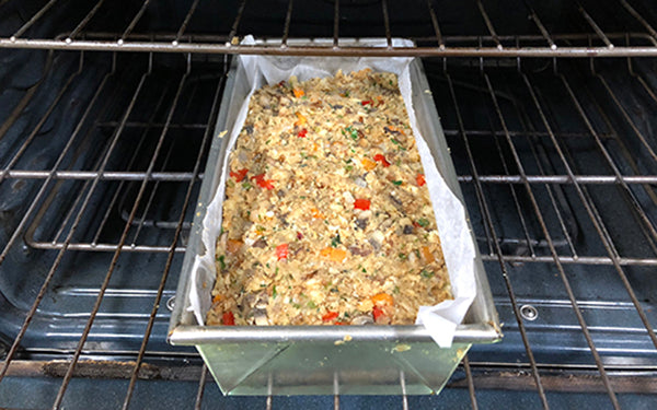 Transfer the mixture to the prepared loaf pan, smooth out the top, cover with foil, and place on a baking sheet. 