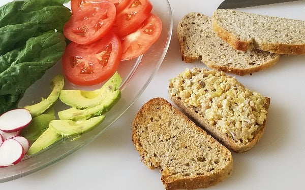 Toast bread, prepare other sandwich toppers. Spread even amounts of chickpea filling on three pieces of bread, layer with toppings then use remaining bread to complete sandwiches.