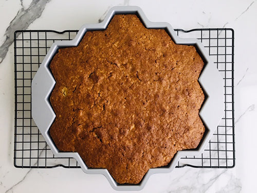 Remove cake and place on a wire rack and cool for 30 minutes. Place a large plate over top of cake pan and turn upside down to release cake from pan.