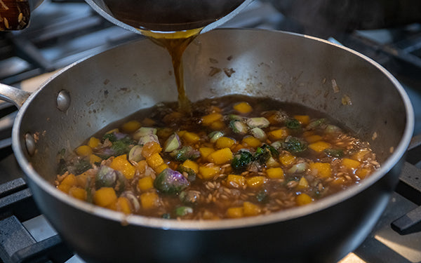Add the hot broth and bring everything to a boil, then reduce to a simmer. 
