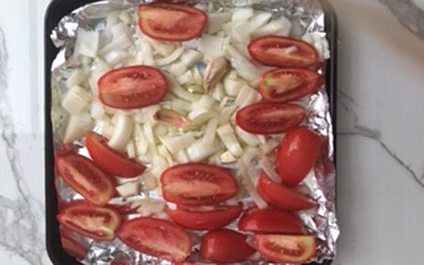 Place tomatoes, onion, garlic, and jalapeño on a foil-lined tray, drizzle with olive oil, then toss with your fingers to lightly coat the veggies. 