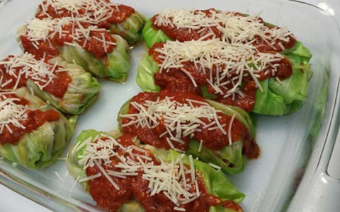 Image of Place cabbage rolls in a baking dish coated with cooking spray or vegetable oil, combine sauce ingredients and spoon over each roll, then top with Parmesan