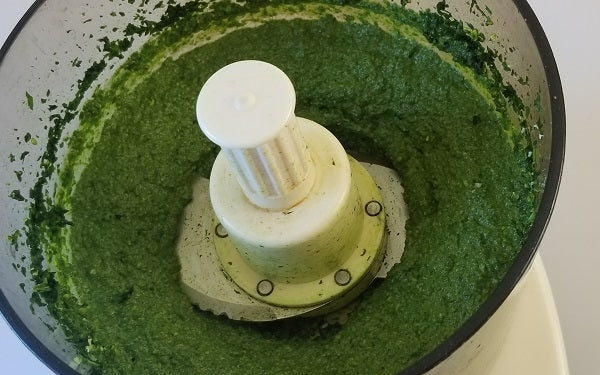 In a food processor, pulse spinach and pine nuts. 