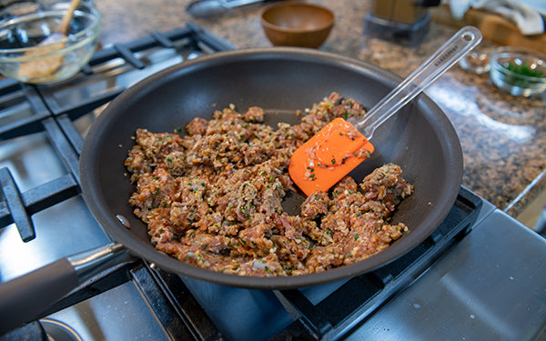 In a large nonstick pan, heat the oil over medium high heat. Add pork and spice mixture. 