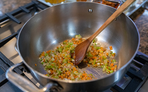 In a soup pot, heat the olive oil and then add the carrots, celery, shallots and garlic. Sprinkle with salt and pepper, and sauté about 4-5 minutes over medium heat.