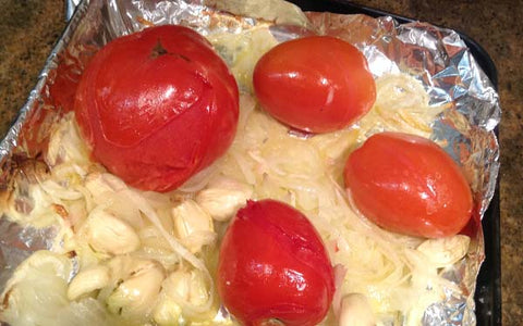 Image of Place the onions, tomatoes, and garlic in a foil-lined baking sheet and drizzle with olive oil and sprinkle with salt. Place in toaster oven for about 20 minutes, or until the tomato skins split and onion is soft. Remove the skins from the tomatoes and roughly chop