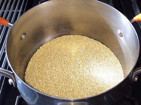 Image of raw quinoa in a saucepan